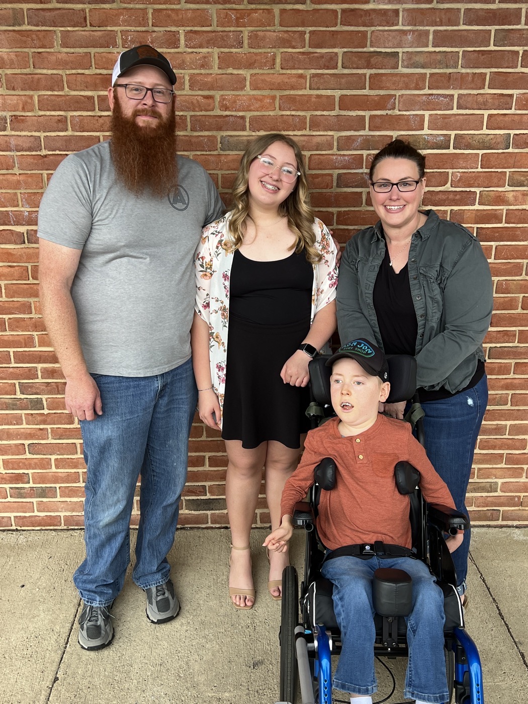 Family portrait of Ben, Ava, Heather, and Jackson in his wheelchair