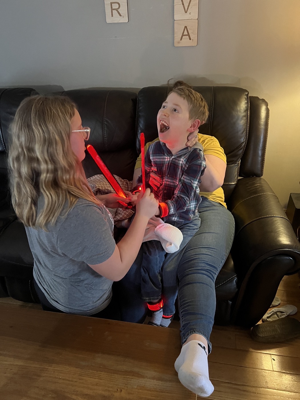 Ava and Heather with Jackson laughing over glowing light sticks